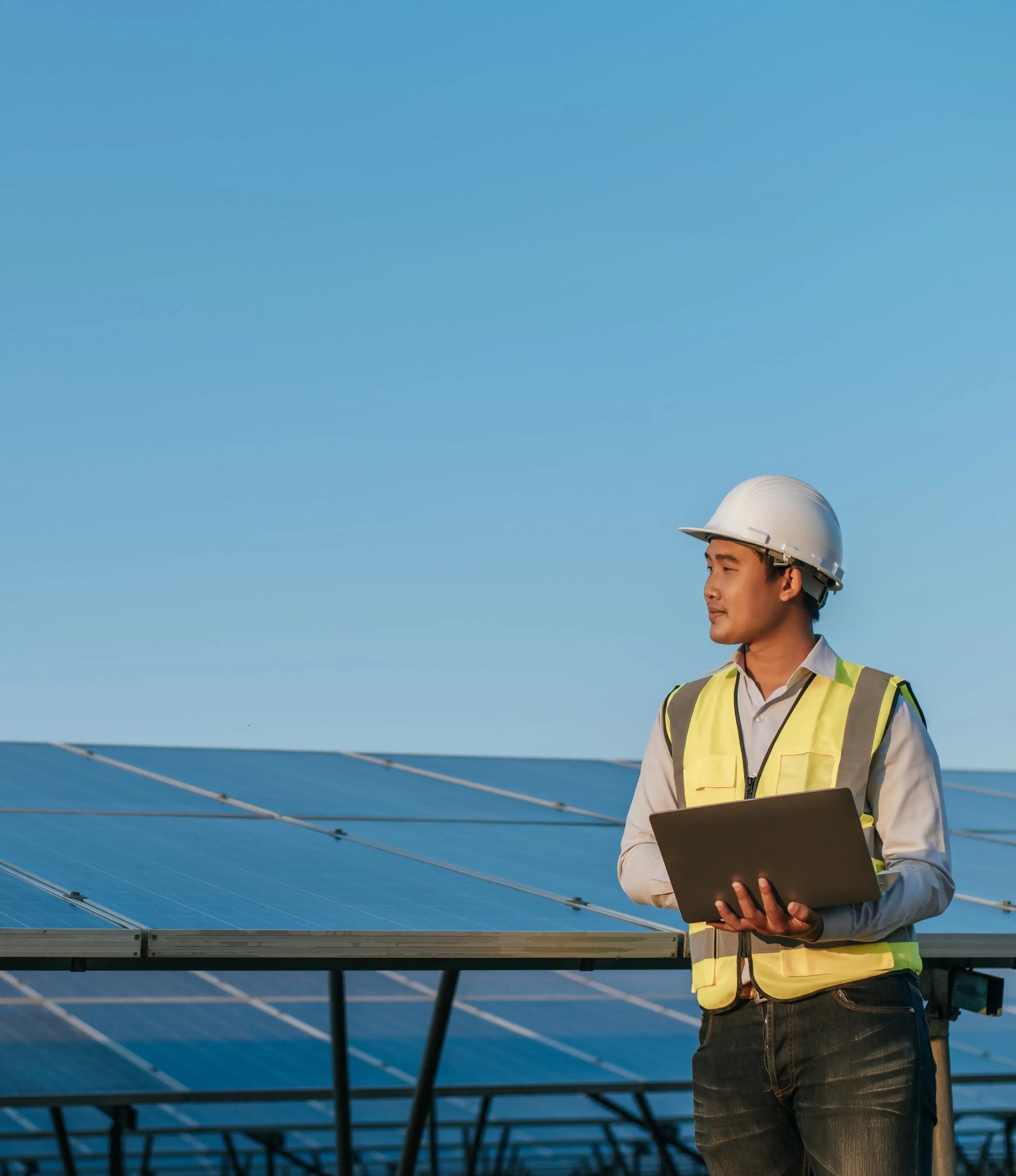 young-asian-inspector-engineer-man-use-laptop-computer-working-solar-farm-technician-supervisor-male-white-helmet-checking-operation-sun-photovoltaic-solar-panel-station-copy-space
